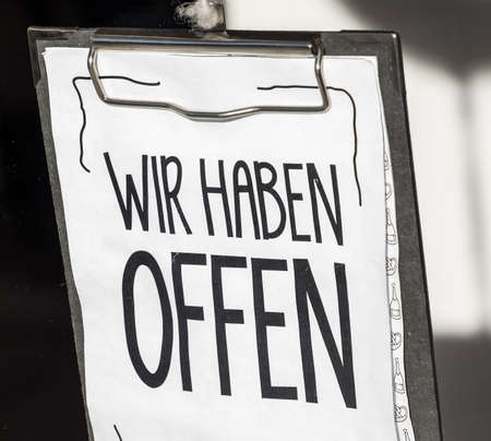open sign at a store in vienna - translation: we are open