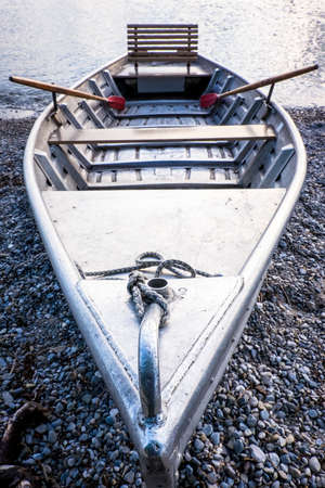 new metal row boat at a lakeの写真素材