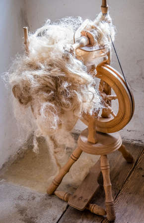 old spinning wheel with woolの写真素材