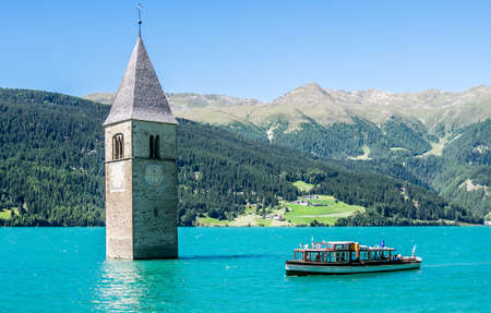 famous historic bell tower at the reschenpass - italyの写真素材