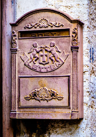 old letterbox at a historic facade