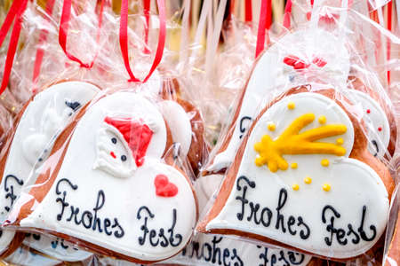 typical souvenir at the oktoberfest in munich - a gingerbread heart - lebkuchenherz - translation: merry christmasの写真素材