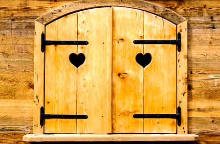 rustic closed window with heartsの写真素材