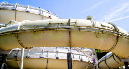 old water slide in front of blue sky