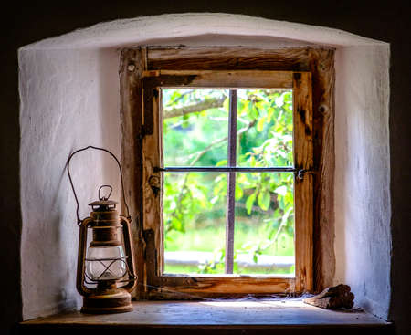 oil lamp at a windowの写真素材