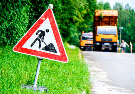 men at work sign at a road construction siteの写真素材