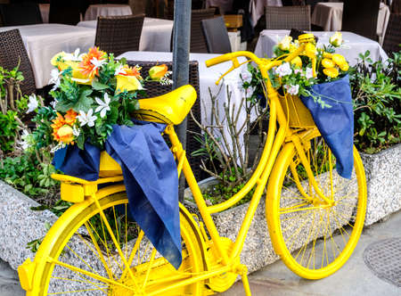 old bike with flowers in italyの写真素材