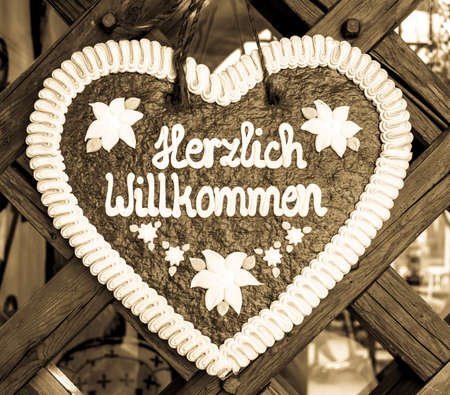 typical souvenir at the oktoberfest in munich - a gingerbread heart - lebkuchenherz - translation: welcomeの写真素材