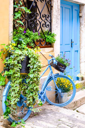 old bike with flowers in italyの写真素材