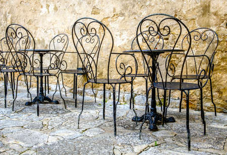 table and chairs at a sidewalk restaurant in croatiaの写真素材