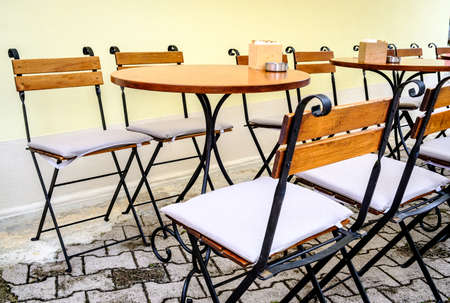 table and chairs at a sidewalk restaurant in croatiaの写真素材