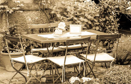 table and chairs at a sidewalk cafeの写真素材