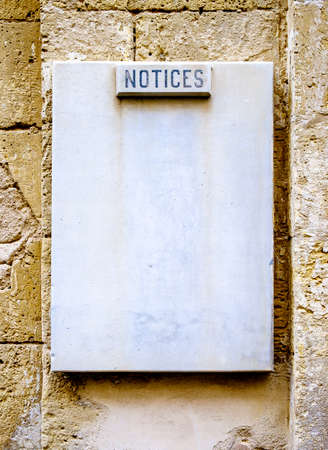 old blank sign at a wallの写真素材