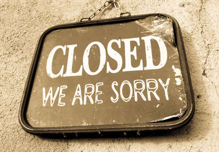 old closed sign at a wallの写真素材