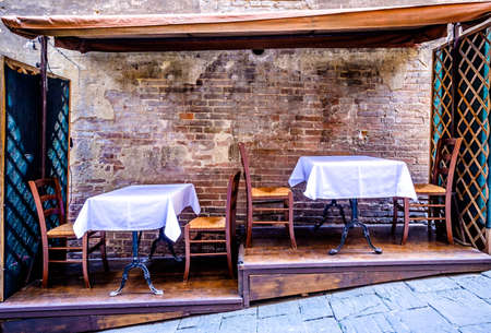 typical sidewalk restaurant in italyの写真素材