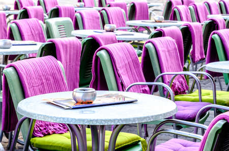 table and chairs at a sidewalk cafeの写真素材