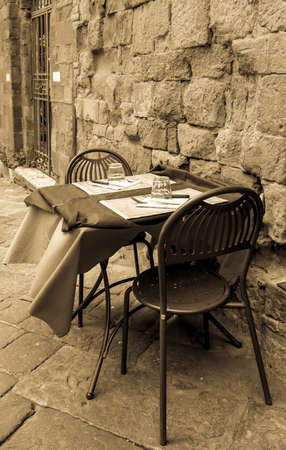 typical sidewalk restaurant in italyの写真素材