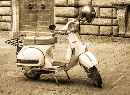 PARMA, ITALY - AUGUST 21: typical Vespa small motorbike at the old street on August 21, 2014 in Parma, Italyのeditorial素材