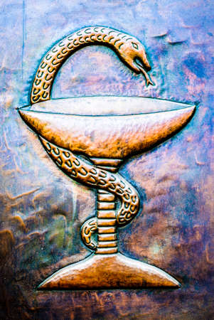 Aesculapian staff - Caduceus at a historic signの写真素材