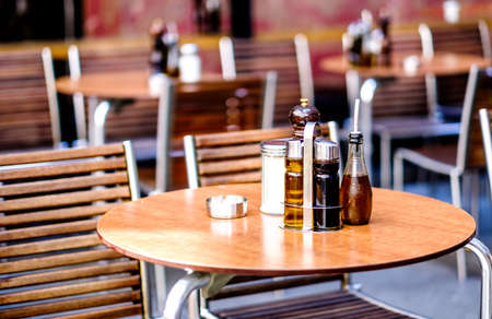 table and chairs at a sidewalk restaurant