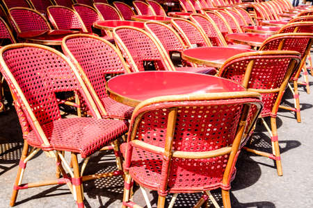 table and chairs at a sidewalk restaurantの写真素材