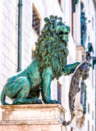 famous bavarian lion at the odeonsplatz in munichの写真素材