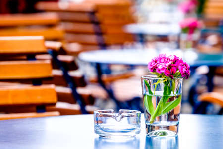 table and chairs at a sidewalk restaurantの写真素材