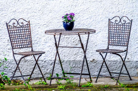 table and chairs at a sidewalk restaurantの写真素材