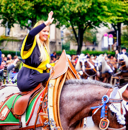 MUNICH, GERMANY - SEPTEMBER 16, 2017: The Oktoberfest is the world biggest beer festival and at the opening parade with rd. 9000 participants take part in historical costumes, music bands and horses.のeditorial素材