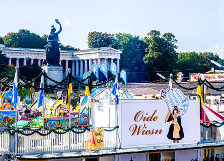 MUNICH, GERMANY - SEPTEMBER 21: people and fairground rides at the biggest folk festival in the world - the octoberfest on september 21, 2017 in munich. Since 1810 it takes place on the Theresienwiese in the Bavarian state capital Munich.のeditorial素材