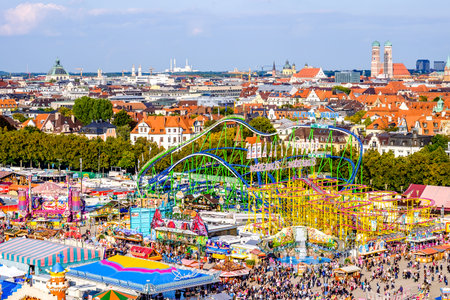 MUNICH, GERMANY - SEPTEMBER 21: people and fairground rides at the biggest folk festival in the world - the octoberfest on september 21, 2017 in munich. Since 1810 it takes place on the Theresienwiese in the Bavarian state capital Munich.のeditorial素材