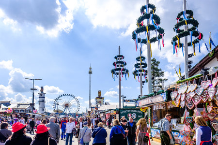 MUNICH, GERMANY - SEPTEMBER 21: people and fairground rides at the biggest folk festival in the world - the octoberfest on september 21, 2017 in munich. Since 1810 it takes place on the Theresienwiese in the Bavarian state capital Munich.のeditorial素材
