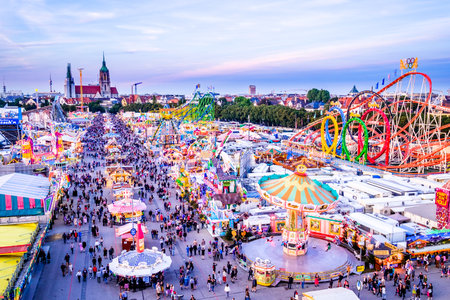 MUNICH, GERMANY - SEPTEMBER 22: people and fairground rides at the biggest folk festival in the world - the octoberfest on september 22, 2016 in munich.のeditorial素材