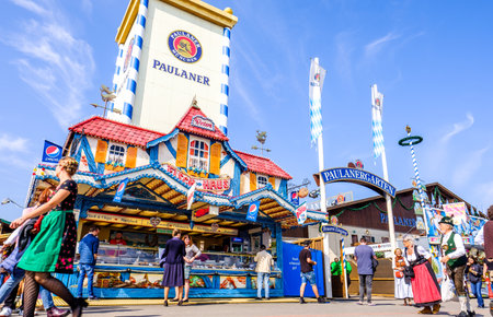 MUNICH, GERMANY - SEPTEMBER 25: people and fairground rides at the biggest folk festival in the world - the octoberfest on september 25, 2017 in munich.のeditorial素材