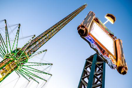 MUNICH, GERMANY - SEPTEMBER 21: people and fairground rides at the biggest folk festival in the world - the octoberfest on september 21, 2017 in munich.のeditorial素材