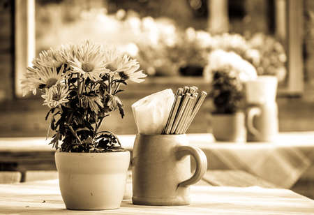 table and chairs at a sidewalk restaurantの写真素材