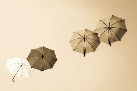 flying umbrellas in front of blue sky