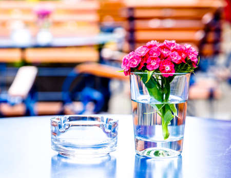 table and chairs at a sidewalk restaurantの写真素材