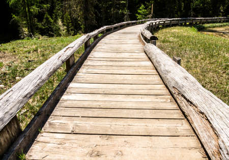 beautiful old wooden bridge at a forestの写真素材