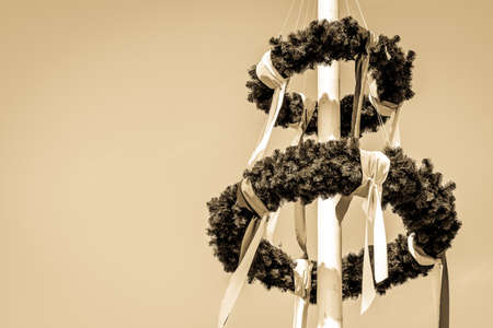 typical bavarian maypole in front of blue sky
