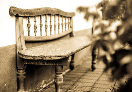 old bench in front of a wallの写真素材