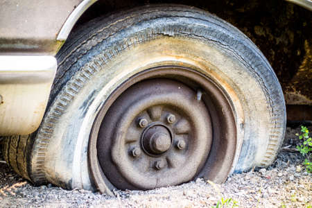 old flat tire of a vintage carの写真素材