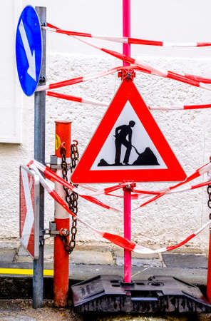 men at work sign at a road construction siteの写真素材