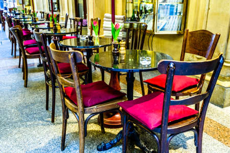 tables and chairs at an old cafeの写真素材