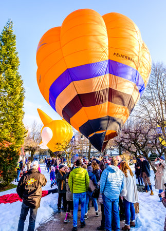 ROTTACH, GERMANY - JANUARY 27: people and small hot air baloons at the montgolfiade event on january 27, 2018 in rottach, germanyのeditorial素材