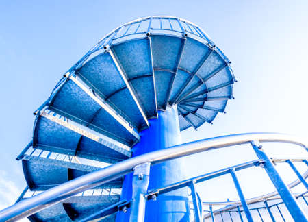 spiral staircase in front of blue skyの写真素材