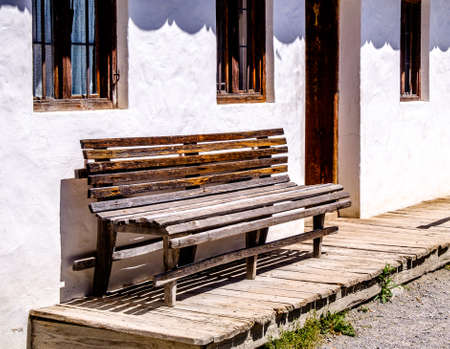 old bench in front of a houseの写真素材