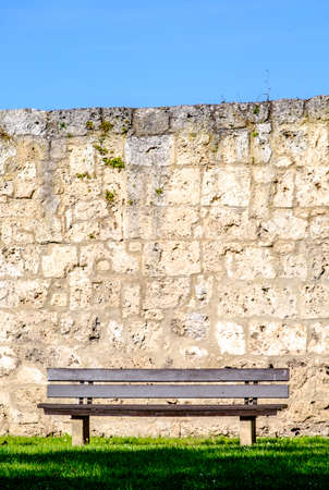 old bench in front of a wallの写真素材