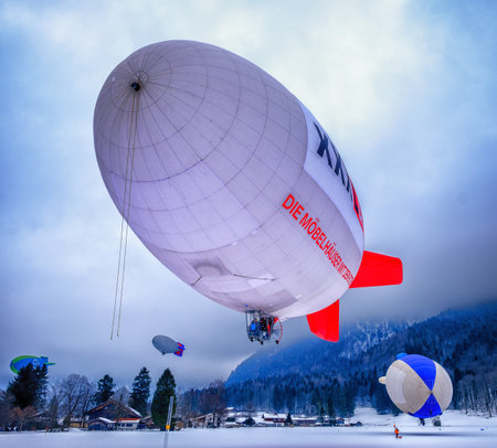 ROTTACH, GERMANY - FEBRUARY 19: blimp (hot air airship) flying at the european alps on feb 19, 2016 in rottach, germanyのeditorial素材