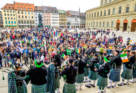 MUNICH - MARCH 11: People celebrating the annual national irish holiday St. Patricks day marching in the old town in munich, germany on  March 11, 2018のeditorial素材